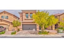 Charming two-story home with a gray two-car garage and well-maintained landscaping at 156 Fulgora St, Henderson, NV 89074