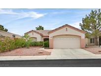 Charming single-story home featuring a two-car garage and desert landscaping at 2103 Poppywood Ave, Henderson, NV 89012