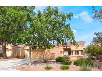 Charming single-story home featuring a well-manicured front yard and a two-car garage at 2505 Showcase Dr, Las Vegas, NV 89134