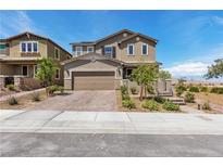 Inviting two-story home featuring a charming front yard with manicured landscaping and a brick-paved driveway at 2601 Gallarate Dr, Henderson, NV 89044