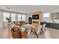 Bright living room featuring modern decor, a stylish fireplace, and comfortable seating at 2601 Gallarate Dr, Henderson, NV 89044