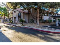 Attractive multi-Gathering building with a desert landscape and red tile roof, shaded by a mature tree at 2606 Durango Dr # 181, Las Vegas, NV 89117