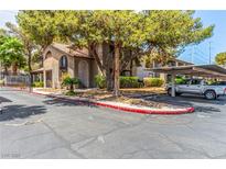Condo complex with covered parking, mature trees, and well maintained landscaping, including gate, curbs and trees at 2606 Durango Dr # 181, Las Vegas, NV 89117