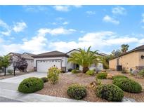 Charming single-story home with a well-manicured front yard, desert landscaping, and a two-car garage at 2651 Solera Moon Dr, Henderson, NV 89044