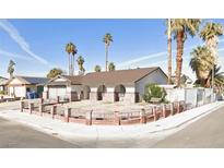 Charming single-story home with a xeriscaped front yard and mature palm trees at 3164 Elmrock Pl, Las Vegas, NV 89121