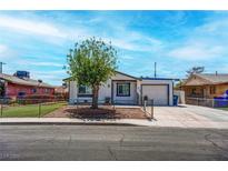Charming single-story home with a well-maintained yard and a driveway leading to an attached garage at 4432 Ash Ave, Las Vegas, NV 89110