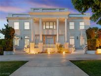 Stately two-story home featuring grand columns, dual staircases, and manicured landscaping at 56 Quail Run Rd, Henderson, NV 89014