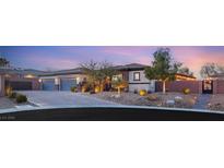 Beautiful single-story home boasting a three-car garage and desert landscaping at 7165 N Grand Canyon Dr, Las Vegas, NV 89149
