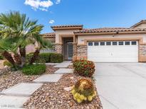 Charming single-story home with well-manicured landscaping and a two-car garage at 7892 Nookfield Dr, Las Vegas, NV 89147