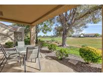 Charming covered patio with golf course views, perfect for outdoor relaxation and entertaining at 8901 Litchfield Ave, Las Vegas, NV 89134