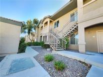 Inviting condominium complex featuring well-maintained landscaping and stairs to upper units at 8985 S Durango Dr # 2081, Las Vegas, NV 89113