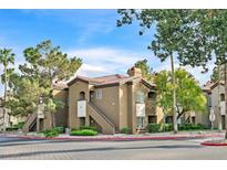 Charming apartment complex featuring stucco facade, red tile roof, and lush landscaping at 9000 Las Vegas Blvd # 1004, Las Vegas, NV 89123