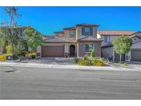 Charming two-story home featuring a two-car garage and professionally landscaped front yard at 10142 Skye Saddle Ave, Las Vegas, NV 89166