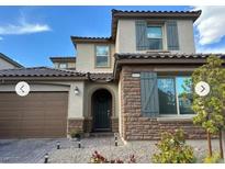 Charming two-story home with a stone facade and a well-manicured front yard at 10142 Skye Saddle Ave, Las Vegas, NV 89166