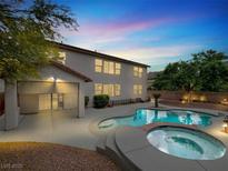 An expansive backyard featuring a pool and spa, perfect for outdoor entertaining at 10392 Smokemont Ct, Las Vegas, NV 89129