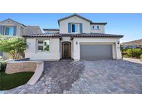 Charming two-story home featuring a beautiful paver driveway and attached two-car garage at 12705 Coastline Shadow St, Las Vegas, NV 89141