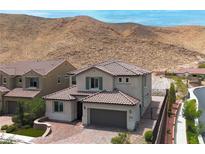 Beautiful home featuring a tile roof, desert landscaping, and mountain views at 12705 Coastline Shadow St, Las Vegas, NV 89141