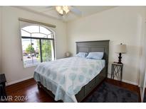 Bedroom featuring a ceiling fan, large window, and light color scheme at 1605 Crimson Hills Dr # 204, Las Vegas, NV 89128
