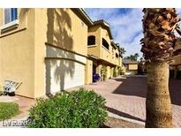 Beautiful townhome features a private garage and lush landscaping at 1605 Crimson Hills Dr # 204, Las Vegas, NV 89128