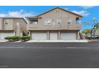 Inviting townhouse complex with attached garages and well-maintained landscaping at 2052 Gravel Hill St # 207, Las Vegas, NV 89117