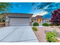 Charming home featuring a two-car garage, low maintenance desert landscaping and a stone facade at 2215 Bannerwood St, Henderson, NV 89044