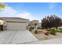 Charming single-story home featuring a well-manicured yard and a two-car garage on a sunny day at 2215 Bannerwood St, Henderson, NV 89044