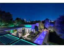 Night aerial view of luxury home with illuminated pool and city skyline at 2323 Pinto Ln, Las Vegas, NV 89107