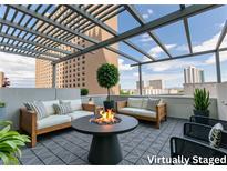 Enjoy outdoor living on this rooftop patio with fire pit, lounge seating, and city views at 2700 Las Vegas Blvd # 505, Las Vegas, NV 89109