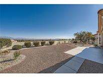Spacious backyard featuring a gravel area, landscaping, and city views at 2904 Bow Bridge Dr, Las Vegas, NV 89134