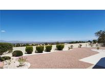 Expansive backyard features low-maintenance landscaping and city views at 2904 Bow Bridge Dr, Las Vegas, NV 89134