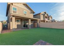 Spacious backyard features an artificial lawn and covered patio, perfect for entertaining at 361 Andy Wheeler Dr, Henderson, NV 89011