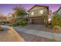 Charming two-story home with a well-manicured front yard and a two-car garage at 361 Andy Wheeler Dr, Henderson, NV 89011