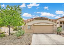 Charming single-story home with desert landscaping and a two-car garage, creating curb appeal at 417 Carlton Kay Pl, Las Vegas, NV 89144