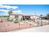 Charming single-story home with a unique desert landscaped front yard and gated entrance at 4412 Baxter Pl, Las Vegas, NV 89107