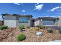 Charming single-story home featuring desert landscaping and a two-car garage, set against a bright blue sky at 4844 E Cactus Canyon Dr, Pahrump, NV 89061