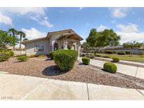 Charming single-story home with well-manicured landscaping and inviting walkway on a sunny day at 4940 Mascaro Dr, Las Vegas, NV 89122