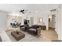 Bright living room featuring stylish furnishings, an open floor plan, and light-colored wood flooring at 5020 Village Dr, Las Vegas, NV 89142
