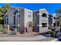 Beautiful apartment building featuring a gray stucco exterior and a terra cotta tile roof at 5055 W Hacienda Ave # 1161, Las Vegas, NV 89118