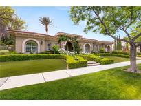 Beautiful single-story home with manicured front lawn, mature landscaping, and welcoming entrance archway at 517 Spruce Canyon St, Las Vegas, NV 89144