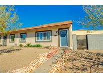 Charming single-story home featuring a quaint walkway and desert landscaping under a bright blue sky at 533 Date St, Boulder City, NV 89005