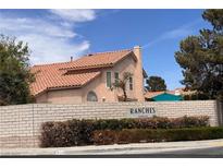 Charming home with a tile roof and brickwork community sign in a well-maintained neighborhood at 5638 Morning Song Cir, North Las Vegas, NV 89031