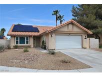 Charming single-story home with a two-car garage, desert landscaping, and a terracotta roof at 5638 Morning Song Cir, North Las Vegas, NV 89031