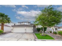 Charming home with a two-car garage, lush landscaping, and brick-lined driveway, creating curb appeal at 760 Camino La Paz, Henderson, NV 89012