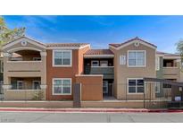 Multi-level apartment building with a combination of beige and brown exterior paint and wrought iron gated fence at 8101 W Flamingo Rd # 2078, Las Vegas, NV 89147