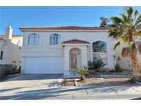 Charming two-story home featuring a desert-landscaped front yard and a white stucco exterior with red tile roof at 8717 Harvest Valley Ave, Las Vegas, NV 89129