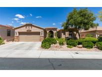 Charming single-story home featuring a two-car garage and desert landscaping at 10372 Premia Pl, Las Vegas, NV 89135