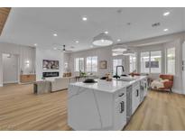 Bright, open-concept living room with modern finishes and a large kitchen island for entertaining at 10886 Porto Foxi St, Las Vegas, NV 89141
