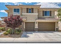 Charming two-story home featuring a two-car garage, stone accents, and a beautifully landscaped front yard at 1113 Via Della Costrella, Henderson, NV 89011