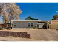 Modest single story home featuring a stucco exterior and partially paved front yard at 155 Magnesium St, Henderson, NV 89015