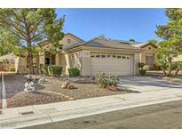 Charming single-story home featuring a two-car garage, desert landscaping, and mature shade tree at 2105 Poppywood Ave, Henderson, NV 89012